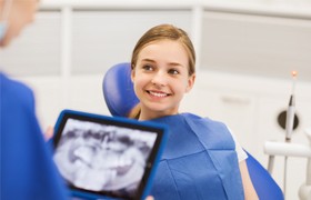 Smiling preteen girl in dental chair