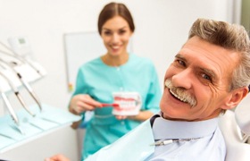 man at a denture consultation with his dentist in Aurora