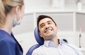 Patient smiling at dentist during exam