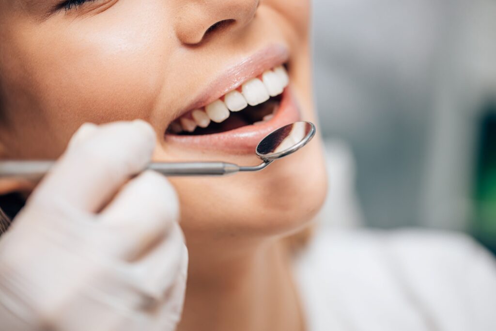 Nose-to-neck view of woman opening her mouth for examination